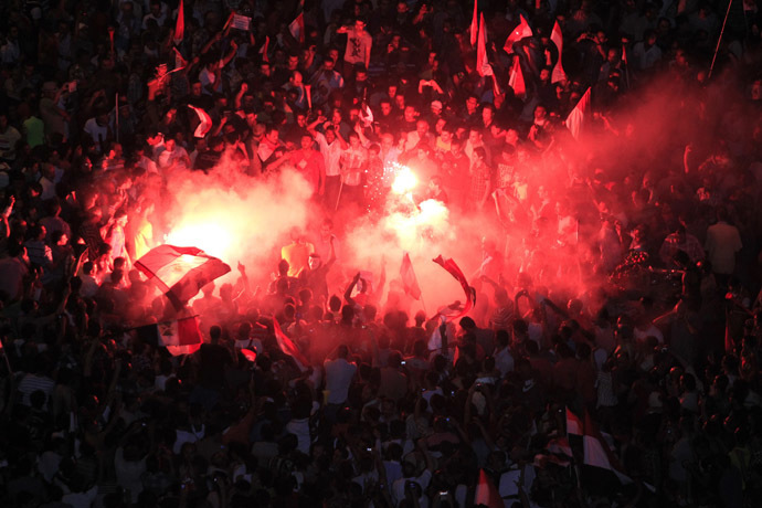 Protesters opposing Egyptian President Mohamed Morsi gather
near a lit a flare during a protest at Tahrir Square in Cairo
June 30, 2013. (Reuters)