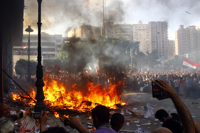 President Mohamed
Morsi burn the content of a Freedom and Justice Party office in
the coastal city of Alexandria on June 28, 2013. (AFP Photo)