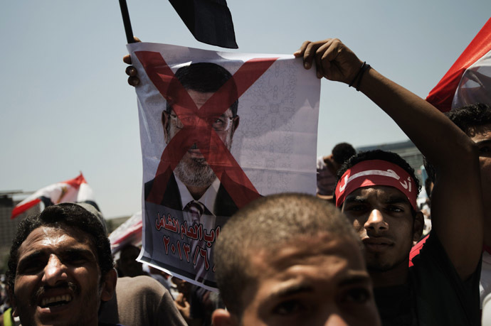 An Egyptian
opposition supporter holds a crossed-out picture of President
Mohammed Morsi as hundreds gather for a demonstration against
Morsi and the Muslim Brotherhood in Cairo's landmark Tahrir
Square on June 29, 2013. (AFP Photo)
