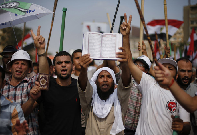Supporters of
Egyptian President Mohamed Morsi hold copies of the Koran during
a protest around the Raba El-Adwyia mosque square in Nasr City,
in the suburb of Cairo June 30, 2013. (Reuters)